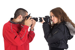 Young man and woman taking pictures of each other